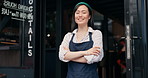 Happy asian woman, cafe and owner by door of small business in confidence for management. Portrait of young female person or waitress smile with arms crossed by professional restaurant or coffee shop