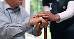 Holding hands, senior man and walking stick with nurse in closeup for recovery, balance and rehabilitation. Retirement, wood cane and elderly person with disability, care and empathy in nursing home