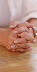 Hands, prayer and woman at table with spiritual meditation, worship and hope for healing. Grief, loss and lonely Christian person praying for support, trust in church and gratitude for God in home.