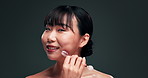 Beauty, smile and jade roller for face with asian woman in studio on dark background for skincare or wellness. Portrait, massage or antiaging and happy young person with product for dermatology