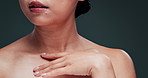 Body, touch or skincare of model, shoulder or beauty in studio isolated on a blue background. Closeup, hands on chest or person with manicure on nails, makeup cosmetics or glow of healthy smooth skin