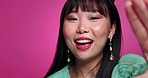 Woman, face and hand for video call with kiss in studio for beauty with Asian cosmetic, makeup or pink background. Female person, smile and mockup space for communication love, gesture or confident