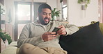 Happy, phone and young man networking on social media, mobile app or the internet on sofa at home. Smile, technology and male person scroll on website with cellphone in living room at apartment.