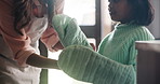 Oven, gloves and child cooking with mom and learning about safety in kitchen closeup. Heat, protection and mother helping kid in home with mittens for hands and teaching with care and support