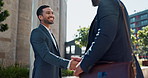 City, business people and handshake with happy employees and smile from project deal and success. Conversation, teamwork and outdoor with staff and urban building with speaking and shaking hands