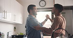 Happy man, gay and dancing in kitchen for love, support or trust in embrace, weekend or holiday together at home. Young male couple or lovers smile in slow dance for LGBTQ, pride or bonding at house