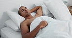 Man, resting and sleeping in bed at home, peace and dreaming or relax on sunday morning. Male person, comfortable and blanket for stress relief, lazy and house nap on soft bedding and calm on weekend