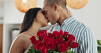 Couple, flowers and kiss for anniversary celebration, marriage and loyalty or commitment to love. People, happy and romance for relationship milestone, bonding and plant gift for support at home