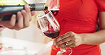 Couple, hands and bottle of red wine for celebration of love, romance and valentines day on their anniversary. People or lover on date with glasses, drinks and alcohol for toast, success and luxury