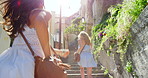 Carefree women running up a set of stairs while on holiday in Italy