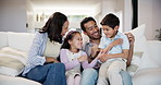 Home, happy family and parents tickle kids, bonding and having fun together. Game, mother and father play with children on sofa in living room, funny and laughing for care in healthy relationship