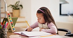 Homework, education and girl writing, learning and ideas with student and child development in a living room. Apartment, notebook and kid at a desk with a pencil and study for math and knowledge