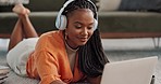 Home, smile and black woman with a headphones, streaming music or sound in a living room. African person on a sofa, apartment or girl with headset, listening to audio or relax with happiness or song