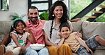 Popcorn, relax and family watching tv together on sofa in living room of home for subscription entertainment. Mother, father and children eating snack in apartment for streaming video on television