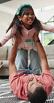 Father, playing and daughter  in living room, house and smile, family home with sofa. Dad, love and care for daughter, happiness and joy with laughter, child and free time for family, games and fun