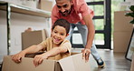 Box, moving and father playing with kid in new home for bonding, fun and quality time together. Happy, excited and young dad push boy child in cardboard at apartment, house or real estate building.