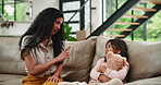 Family, teaching or discipline with mother and girl on sofa in living room of home together. Education, learning or child development with strict parent and daughter in apartment for correction