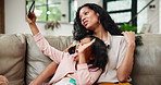 Family, selfie and mother on sofa with daughter in living room of home for funny or playful picture. Love, smile or happy with woman and girl child in apartment to relax for photograph or bonding