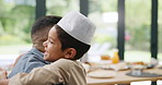 Dad, hug and muslim child in home, dressing and happy family bonding together on Ramadan kareem. Islam, smile and father embrace kid in hat to help button clothes for love, care and support on Eid