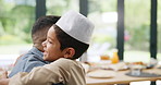 Father, hug and muslim child in home, dressing and happy family bonding together for relationship. Islam, smile and dad embrace kid in hat to help button clothes for love, care and support on Eid