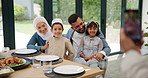 Islamic, photograph or happy family in home at lunch with smile or celebration of Eid or Ramadan in Dubai. Muslim child, people eating food or profile picture at dinner meal with parents, dad or mom