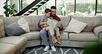 Father, son and reading a book on couch for learning, teaching and education for knowledge and bonding in home. Family, man and boy child with storytelling on sofa for helping, development or support