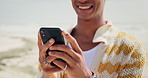 Phone, hands and happy man at a beach with social media, chat or texting outdoor closeup. Smartphone, app and male person at the ocean with online, internet for meme, search or gif communication