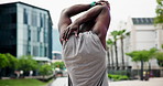 Fitness, stretching and man in city street for body, warm up or marathon training, run or morning cardio. Exercise, workout or male back with arm stretch outdoor for running, performance or challenge