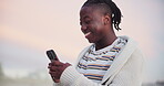 Man, phone and laughing for communication on vacation, humor and funny conversation on holiday. Black male person, comedy and scrolling on social media at beach, online and typing on mobile app