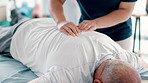 Physiotherapy, back massage and chiropractor with senior man in medical office at clinic. Rehabilitation, patient and closeup of healthcare worker helping elderly male person healing muscle pain.