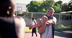 Sports, basketball and athletes warm up for arms with training, game or match on outdoor court. Fitness, team and group of young African male people with stretching workout or exercise on pitch.