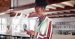 Fashion, design and black woman with phone, typing and networking for creative small business in workshop. Smartphone, tailor or professional designer writing email, search or online chat at startup.