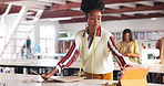 Black woman, designer and fashion in studio with tablet for ecommerce, strategy and ideas for retail business. Female stylist, paper and technology in workshop for draft, template or supply chain