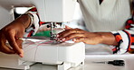Hands, sewing machine and thread prepare in studio for fabric manufacturing, small business or production. Person, fingers and equipment in workshop for fashion or ecommerce, pattern or creativity