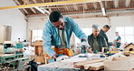 Engineering, production and man carpenter with grinder in a workshop manufacturing furniture. Woodwork, industry and African male industrial worker working and building timber with tools in warehouse