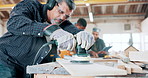 Wood, sander and carpenter in workshop with tools for furniture, production or construction project. Handyman, building and woodworking process in warehouse with manufacturing or labor in business