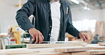 Hand, measuring tape and woodwork in workshop for production of furniture for small business, carpentry or build. Person, manufacture and contractor with timber plank in factory for job, diy or craft