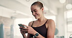 Happy woman, laughing and phone at gym for fitness, workout or training meme, social media and chat. Young person typing on mobile for communication, exercise break and reading message or networking