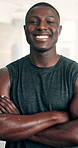Happy, black man and fitness with arms crossed in confidence for workout, exercise or training at indoor gym. Portrait of confident African male person with smile for muscle, bodybuilding or health