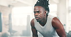 Fitness, sweating and breathing with black man in gym to rest from workout for health or cardio. Exercise, tired and intensity with exhausted young athlete training for performance or improvement