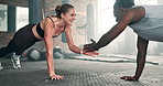 Woman, personal trainer and push ups on floor at gym for teamwork, workout or exercise together. Interracial people, coach or mentor lifting body in training, muscle gain or strength at health club