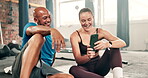 Couple of friends, fitness and gym with phone for social media, funny meme and laughing of fitness joke. Young personal trainer, boxer or people reading chat, blog or watch sports on mobile and break