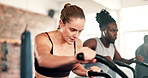 Exercise, cardio and woman on machine in gym for intense workout, training and fitness for healthy body. Sports, sweating and people on cycling equipment for performance, endurance and wellness