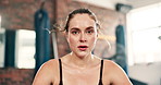 Tired, face or fitness woman breathing at a gym for training, exercise or intense morning cardio. Sports, portrait or athlete sweating on recovery break from body workout, challenge or performance