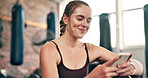 Happy, fitness and woman with phone in gym for social media, text message and online chat after workout. Sports, typing and person on smartphone or mobile app for training, exercise and wellness