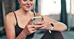 Relax, fitness and woman with phone in gym for social media, text message and online chat after workout. Sports, typing and person on smartphone or mobile app for training, exercise and wellness