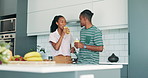 Love, smile or black couple in a kitchen with orange juice, care or gut health morning routine at home. Wellness, support or African people bonding with vitamins, drink or breakfast, smoothie or chat