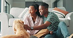 Love, happy couple and bonding with dog by sofa in living room and care for domestic animal in home. Black people, labrador and playing with cute pet in lounge and relax together for fun on weekend