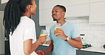 Couple, drinking juice and conversation for love in morning, bonding and smoothie or nutrition at home. Black people, happy and communication in kitchen, wellness and security in marriage or diet