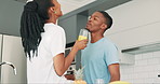 Black couple, kitchen and conversation in a home with love, smile and bonding together with food. Happy, support and marriage with trust and relax from juice and fruit  in house at morning with chat